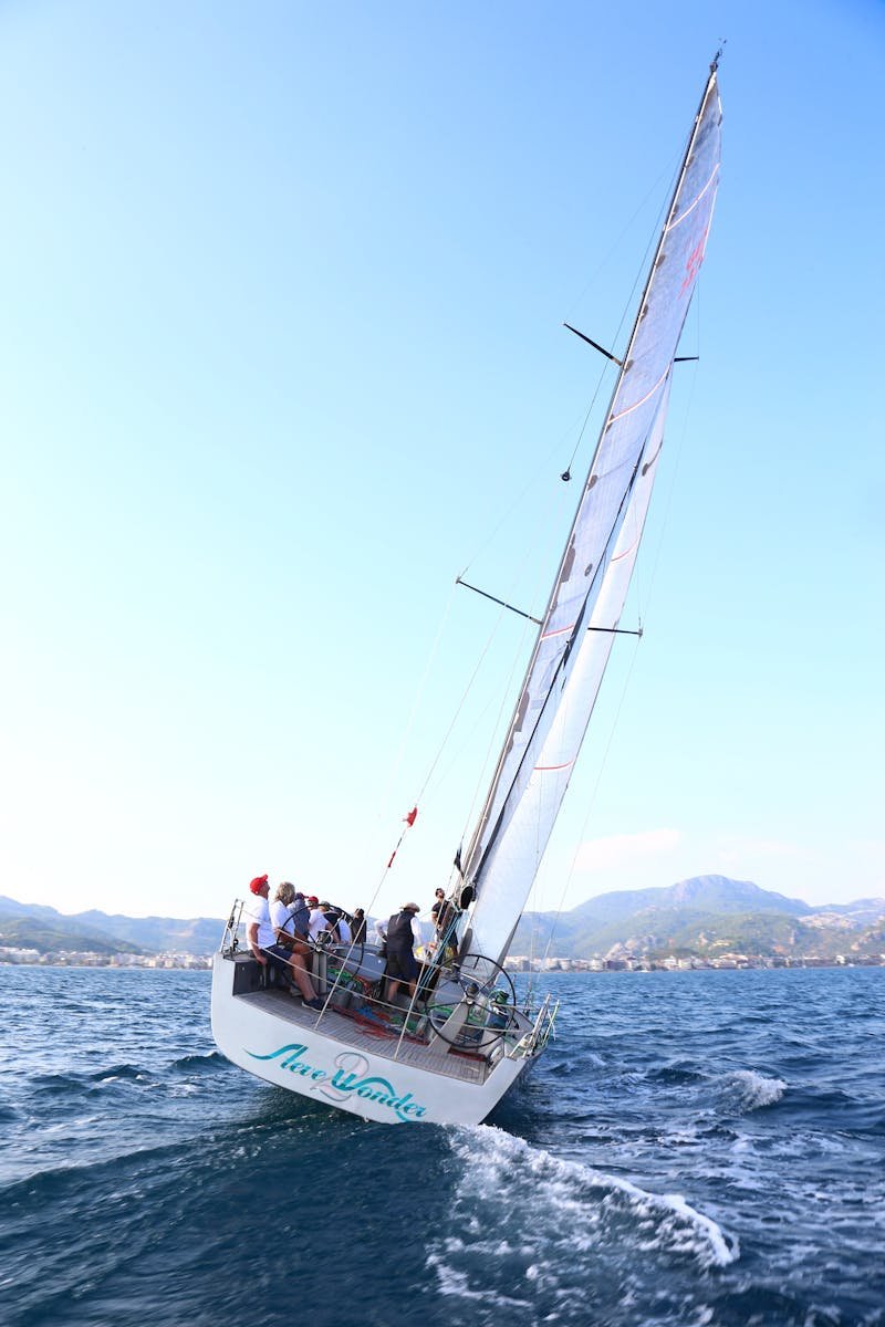 IanTheSkipper Almerimar Almería Group enjoying a sailing adventure on open waters with scenic mountain views.